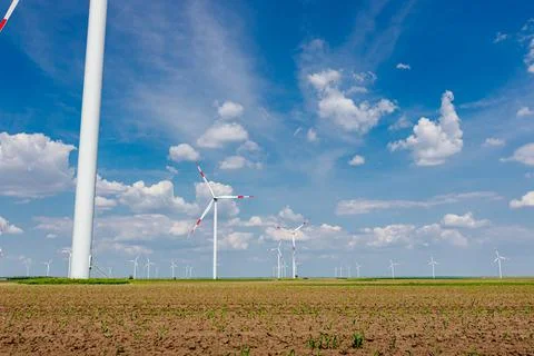 View on several windmills, wind generators, turbines, producing renewable Stock Photos