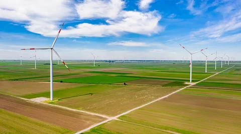View on several windmills, wind generators, turbines, producing renewable Stock Photos