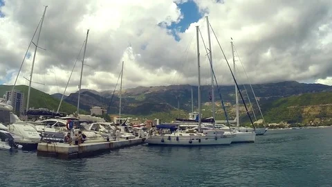 View of several yachts docked along the pier near island. Video stock 80245294