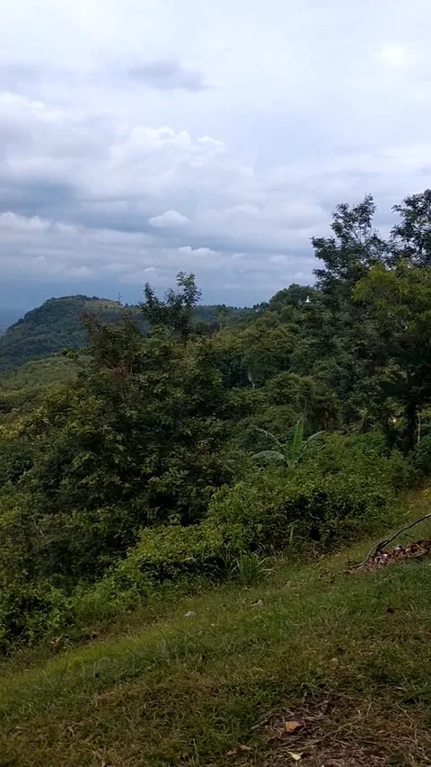 View of shady hills under cloudy skies Stock Footage 325652135