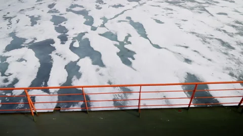 View from ship deck with orange safety railing overlooking partially frozen sea Stock Footage 318293809