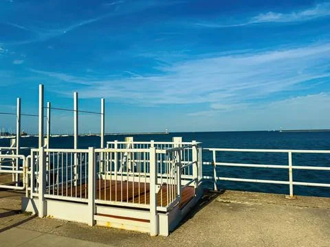 View from a ship deck over the ocean with railings and sky Stock Photos