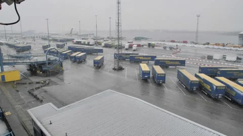 View from the ship to the parking lot with trailers waiting to be loaded onto Stock Footage 276501860