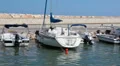 View from ship passing behind moored boats and yachts in bay of Latchi, Cyprus HD Footage