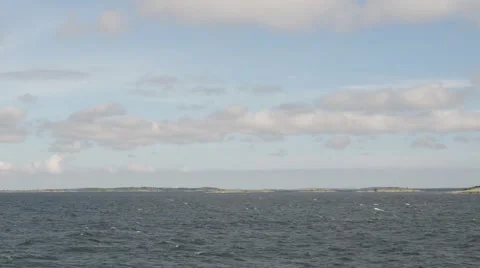 A  view from a ship with small islands going by in the horizon Stock Footage 55724993