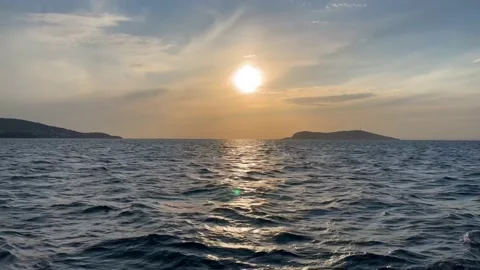 View from the ship to the sunset above the islands - Vertical stock video Stock Footage 239640936