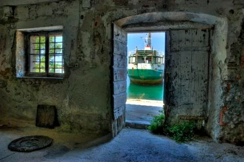 View of a Ship Through a Door in Ugljan, Croatia Stock Photos