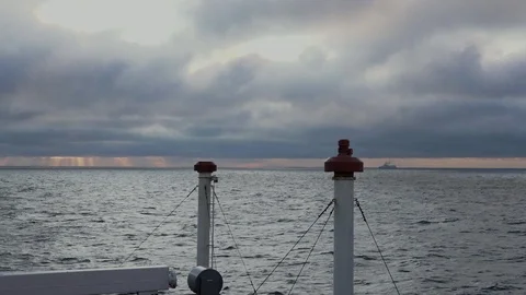 View from ship on tranquil sea and heavy clouds at sunset Stock Footage 121117286