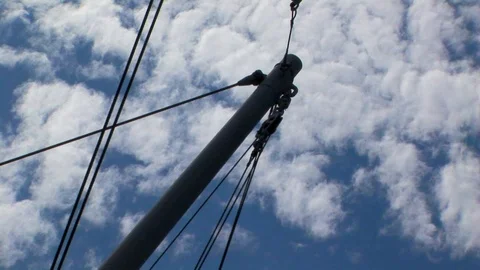 View of ship’s spar against a cloudy blue sky Stock Footage 101561706