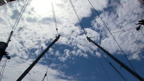 View of ship’s spars against a cloudy blue sky Stock Footage 101561790