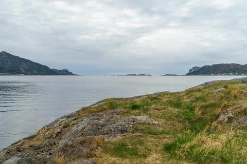 View from shore to cloudy sea 库存照片