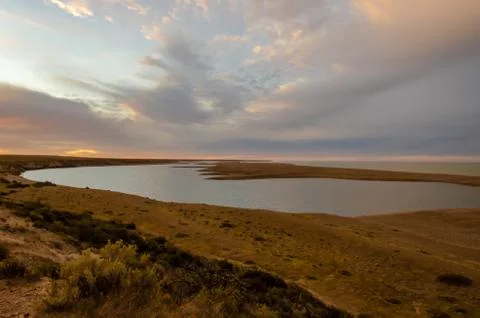 View of a shore with a lake on sunset Stock Photos
