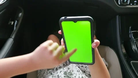 View from shoulder of asian child doing swipe up gesture on chroma key of m.. 스톡 동영상 279295160