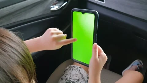 View from shoulder of asian child doing swipe up gesture on chroma key of m.. Stock Footage 279295163