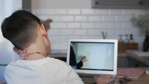 A view from the shoulder of a boy doing homework. Stock Footage 172306248