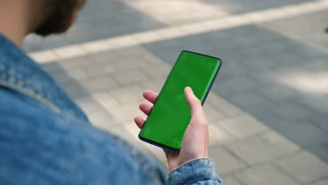 View from shoulder of caucasian man doing swipe up gesture on chroma key of Stock Footage 196118727