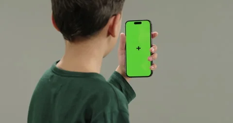 View from shoulder of kid talking to camera recording vlog for social media blog Stock Footage 260758536