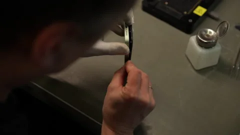 View from shoulder of technician disassembling mobile phone, taking apart Stock Footage 307448320