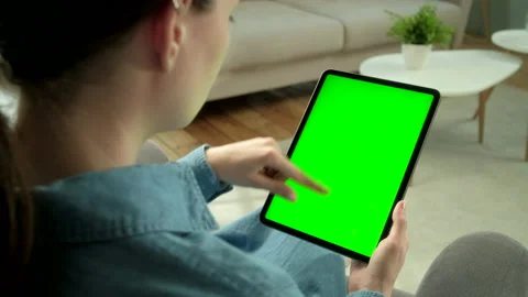 View From the Shoulder of Woman Using Hand Gestures on Green Mock-up Screen Stock Footage 133286749