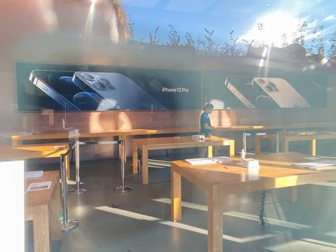 View from the showcase at Empty shelves of Apple Store with no customers inside 스톡 사진