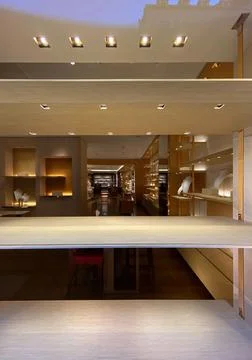 View from the showcase at Empty shelves of Louis Vuitton store with no customers 스톡 사진