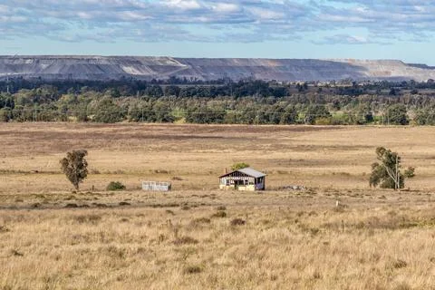 View showing the contrast between a coal mine and adjacent rural farmland Stock Photos