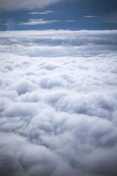 A view shows thick clouds spread across the sky. Blue areas peek through th.. Stock Photos