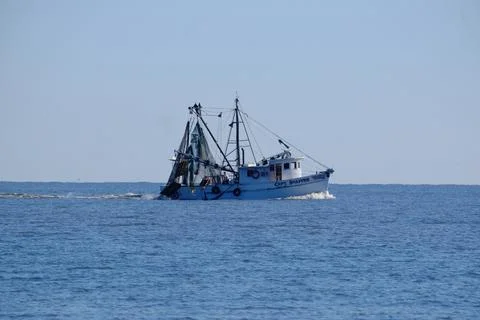 View of a shrimp boat in the sea on a sunny summer day Stock Photos