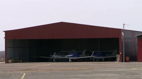 View of shrouded aircraft in hangar Видео 54207553