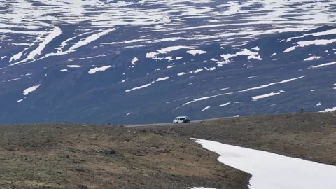 View of a shuttle bus and tourists on the scenic road to Galdhøpiggen, Norgway Stock Footage 250440904