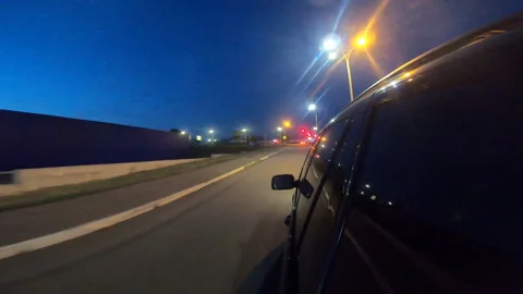 View from side of black suv driving through city highway at night. Automobile Stock Footage 157970146