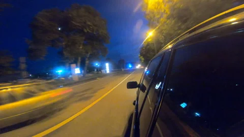 View from side of black suv racing through countryside highway at night Stock Footage 309102940