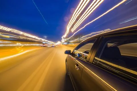 View from Side of Car moving in a night city Stock Photos