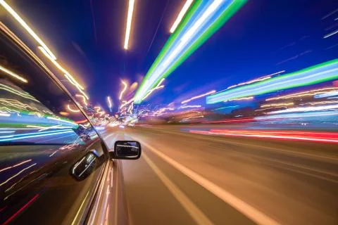 View from Side of Car moving in a night city Stock Photos