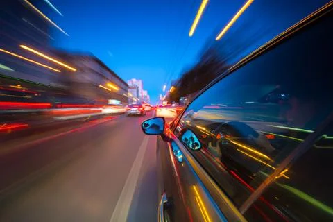 View from Side of Car moving in a night city Stock Photos