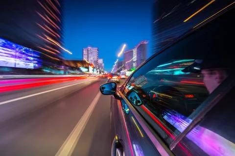 View from Side of Car moving in a night city Stock Photos