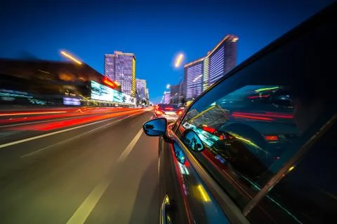 View from Side of Car moving in a night city Stock Photos
