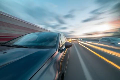 View from Side of Car moving on a sunset highway Stock Photos