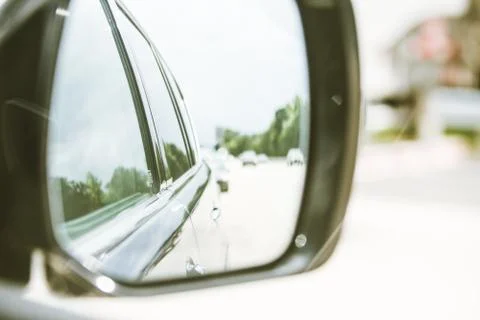 View of side of car through side mirror Stock Photos