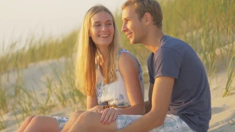 View from side of lady talking to her boyfriend on the beach Video stock 73782361