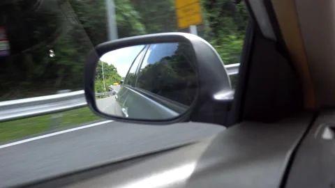 View of the side mirror of car. Left-hand traffic Stock Footage 190077069