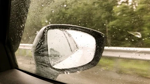 View in the side mirror of the car while driving. It's raining Stock Footage 113326206