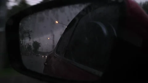View from the side mirror driving in the rain from inside the car. Stock Footage 174089802