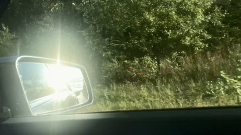 View in side mirror from vehicle on highway. Driving a car along forest. Stock Footage 118249833