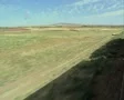 View from side of moving train of countryside SD Footage