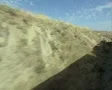 View from side of moving train of desert countryside SD Footage