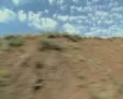 View from side of moving train of dry countryside SD Footage