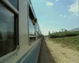 View up side of moving train with woman at window SD Footage