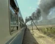 View up side of moving train with woman at window SD Footage