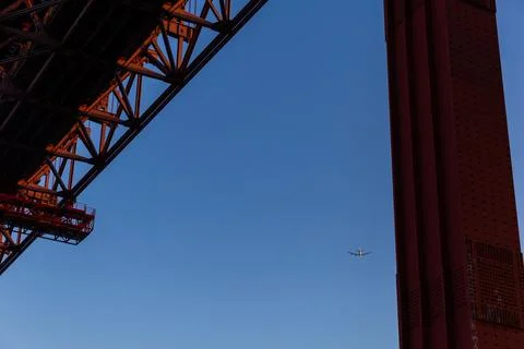 View of side red bridge and airplane fly on the blue sky Stock Photos